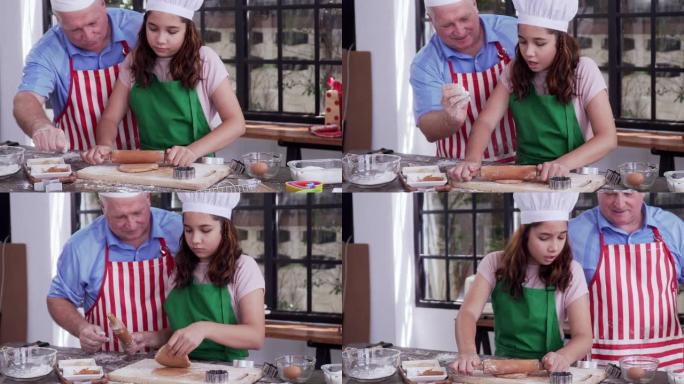 爸爸正在教他的女儿如何在厨房里煮饼干面团。女儿帮助爸爸学习在家一起烤饼干。烹饪家庭、教育、爱、乐趣、