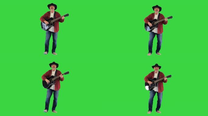 牛仔男子与原声吉他在绿色屏幕上唱歌，色键