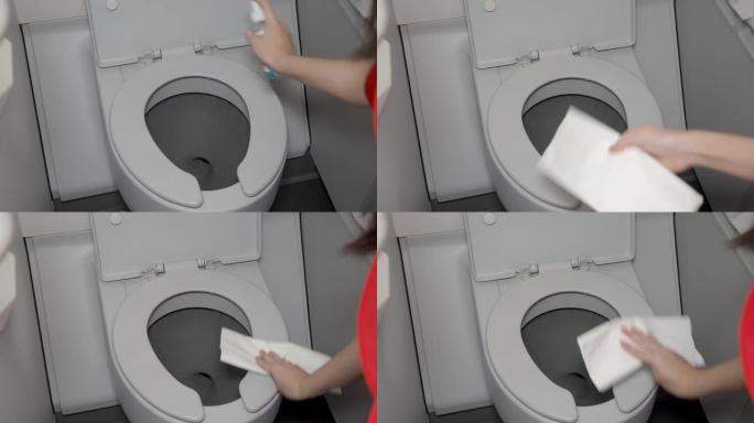 特写女性手擦拭飞机厕所马桶，清洁习惯，飞机洗手间门上的细菌，电晕病毒covid19，公共卫生问题，概