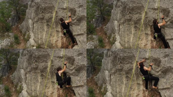 年轻人在岩石上练习自由攀爬