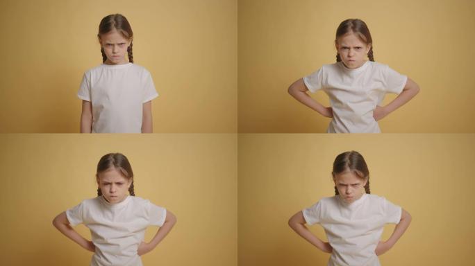 穿着白色t恤的小女孩对背景慢动作的黄色墙生气