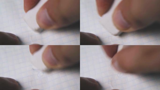 man fingers使用橡皮擦从纸张微距中删除图片