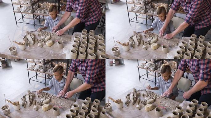 高加索人有爱心的父亲帮助小儿子制作陶瓷花瓶