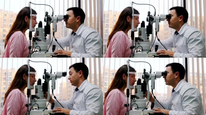 眼科治疗-医生用大型验光机检查年轻女性的视力-带百叶窗的全景窗户的宽敞橱柜