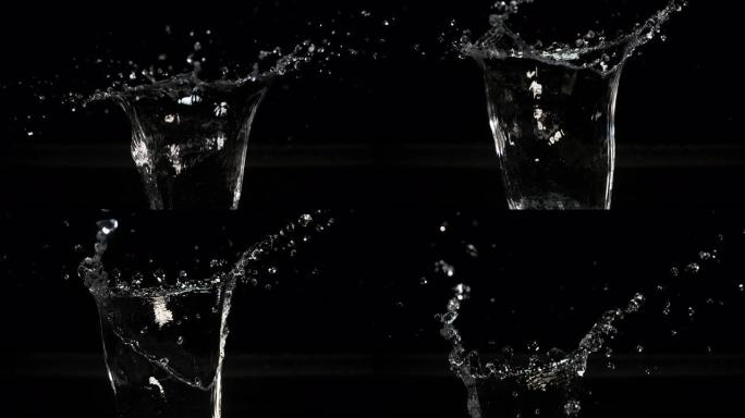 黑色背景下的水爆炸和飞溅，慢动作4K
