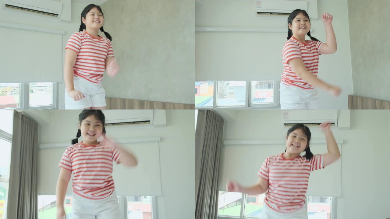 可爱漂亮的年轻亚洲女性休闲布舞跳跃和快乐唱歌白色软床4k慢动作镜头