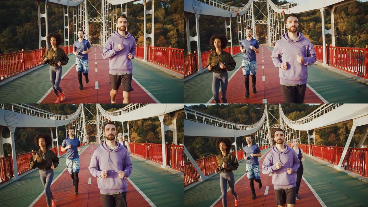 为马拉松做准备。一群积极进取的跑步者早上在运动桥上慢跑