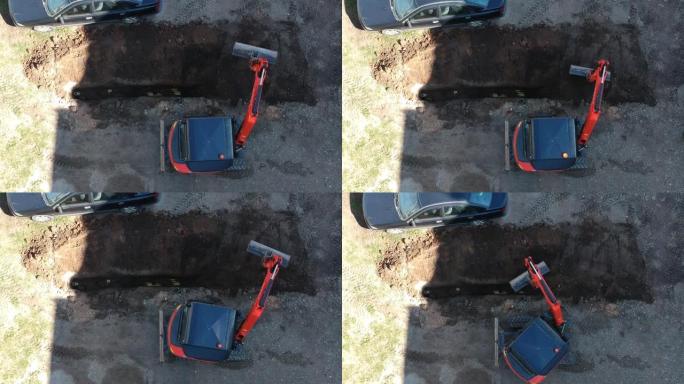小型挖掘机履带式装载机埋入城市街道沟渠，空中