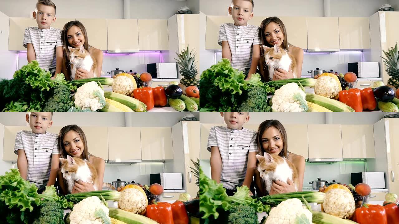 厨房和蔬菜。妈妈带着一个孩子和一只猫在厨房里准备健康的食物。