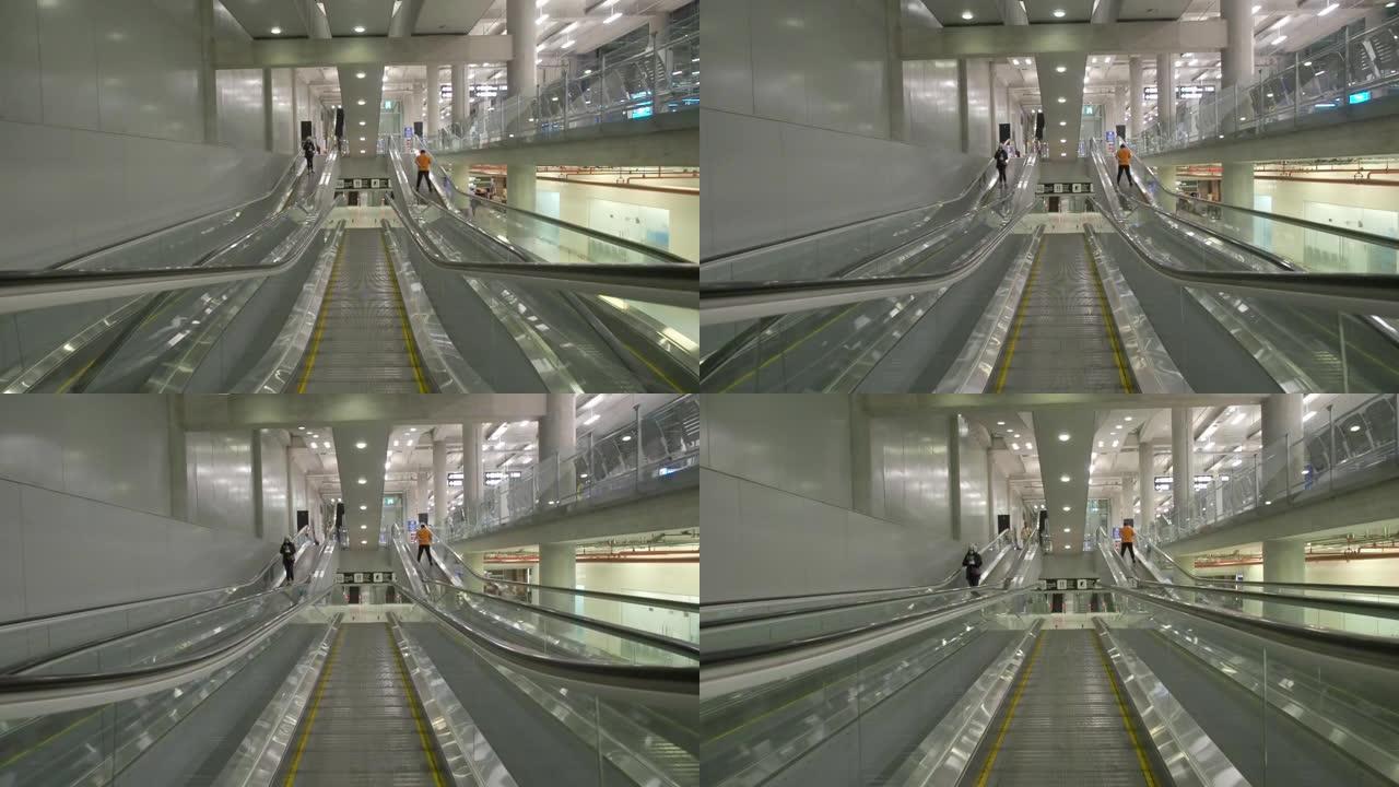 许多现代自动扶梯在机场航站楼内移动。由于新型冠状病毒肺炎和冠状病毒大流行爆发，很少有乘客使用。