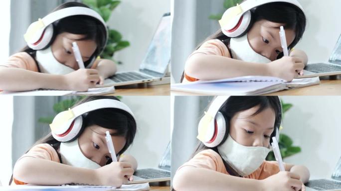 亚洲女孩在新型冠状病毒肺炎期间学习家庭电子学习，生活方式概念。