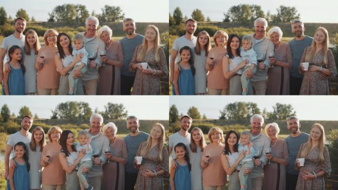 快乐的大家庭站在户外，微笑着摆姿势拍照