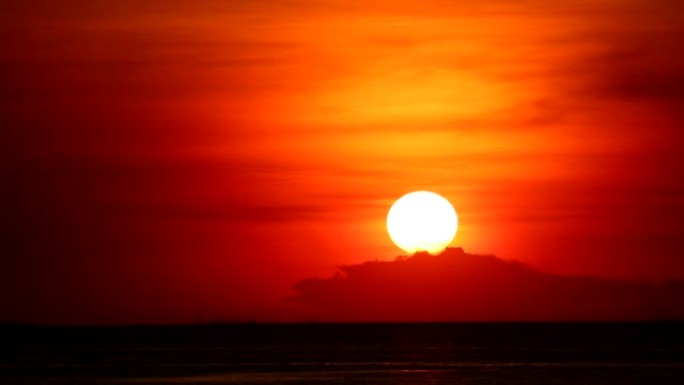 红色橙色天空上的日落回到浅橙色云和黑暗的海洋时间流逝