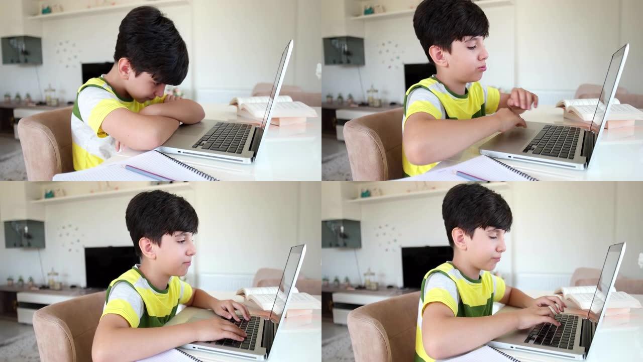 十几岁的男孩使用笔记本电脑做作业