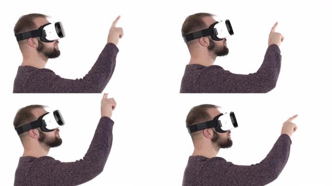 使用虚拟现实眼镜的年轻人感到惊讶。震惊的白人男子穿着VR google用食指指着某物