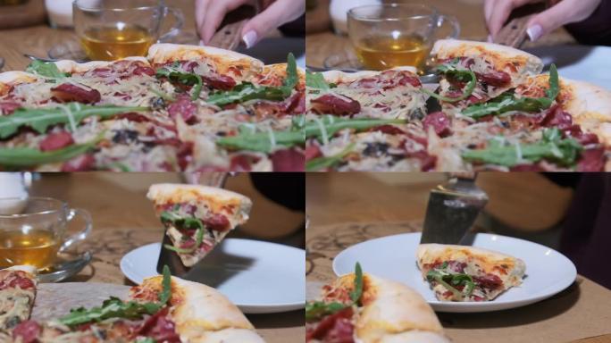 女人的手从餐厅的木盘里拿了一片披萨。慢动作