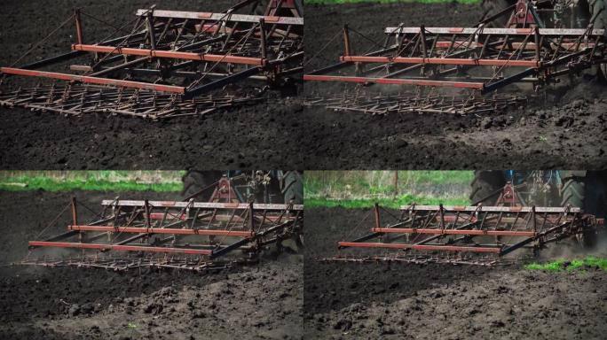 拖拉机在田里耕种和切割犁沟。村里黑土田里的拖拉机作业