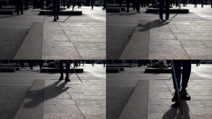 盲人女人用棍子走在街上。独立，自主，失明