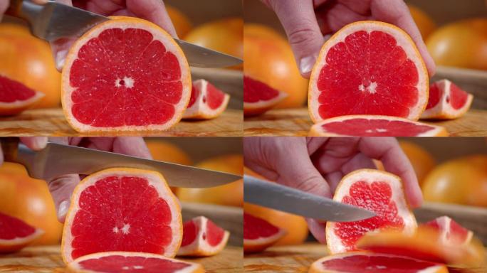 男性用刀切割成熟的葡萄柚片。