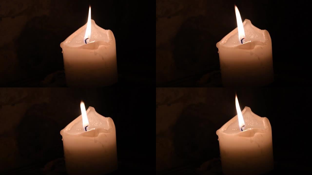 黑暗中融化的蜡烛火焰。纪念概念。哀悼日