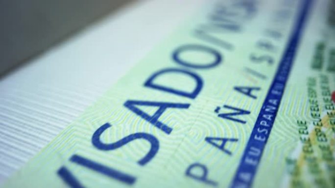 外国护照上的西班牙签证。申根签证文件。旅游的概念