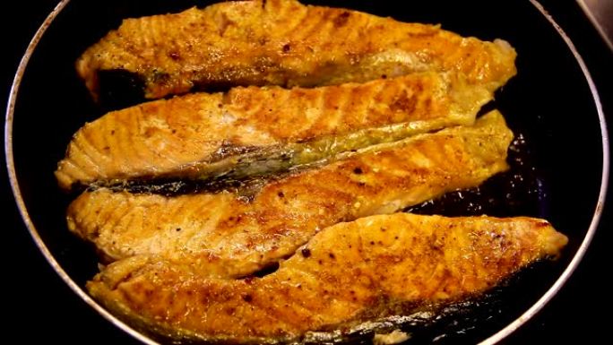 鲑鱼片在烹饪锅上用橄榄油油炸。新鲜鲑鱼海鲜。高清格式