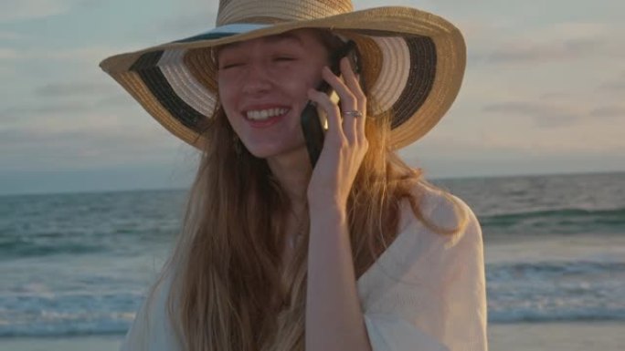 日落时，年轻女子在海边打电话