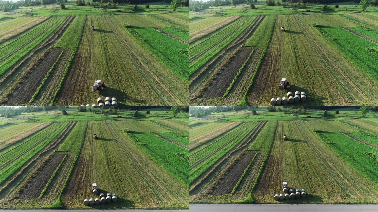 农业田间打捆干草拖拉机上的无人机观点-库存视频
