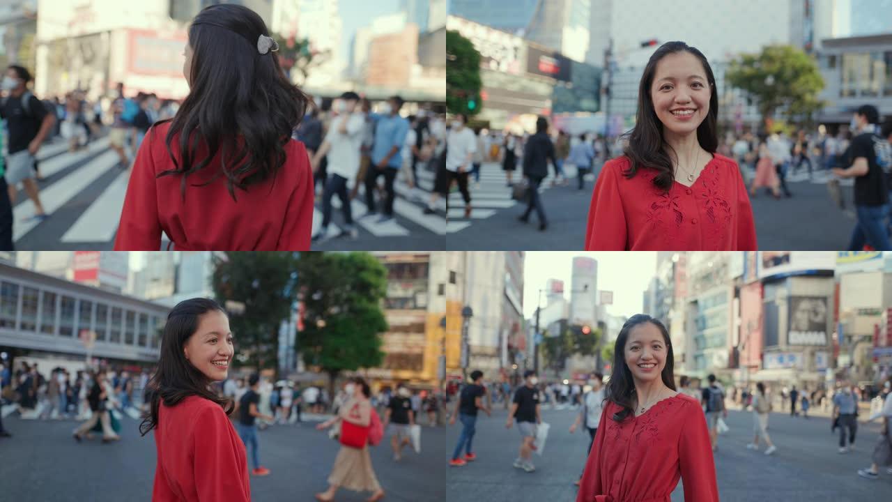 身穿红色连衣裙的年轻女子站在涩谷十字路口，看着相机
