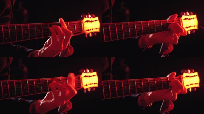 演奏红色背光和黑色背景的原声吉他