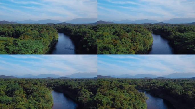 巴西河热带绿色森林的鸟瞰图，背景为山脉