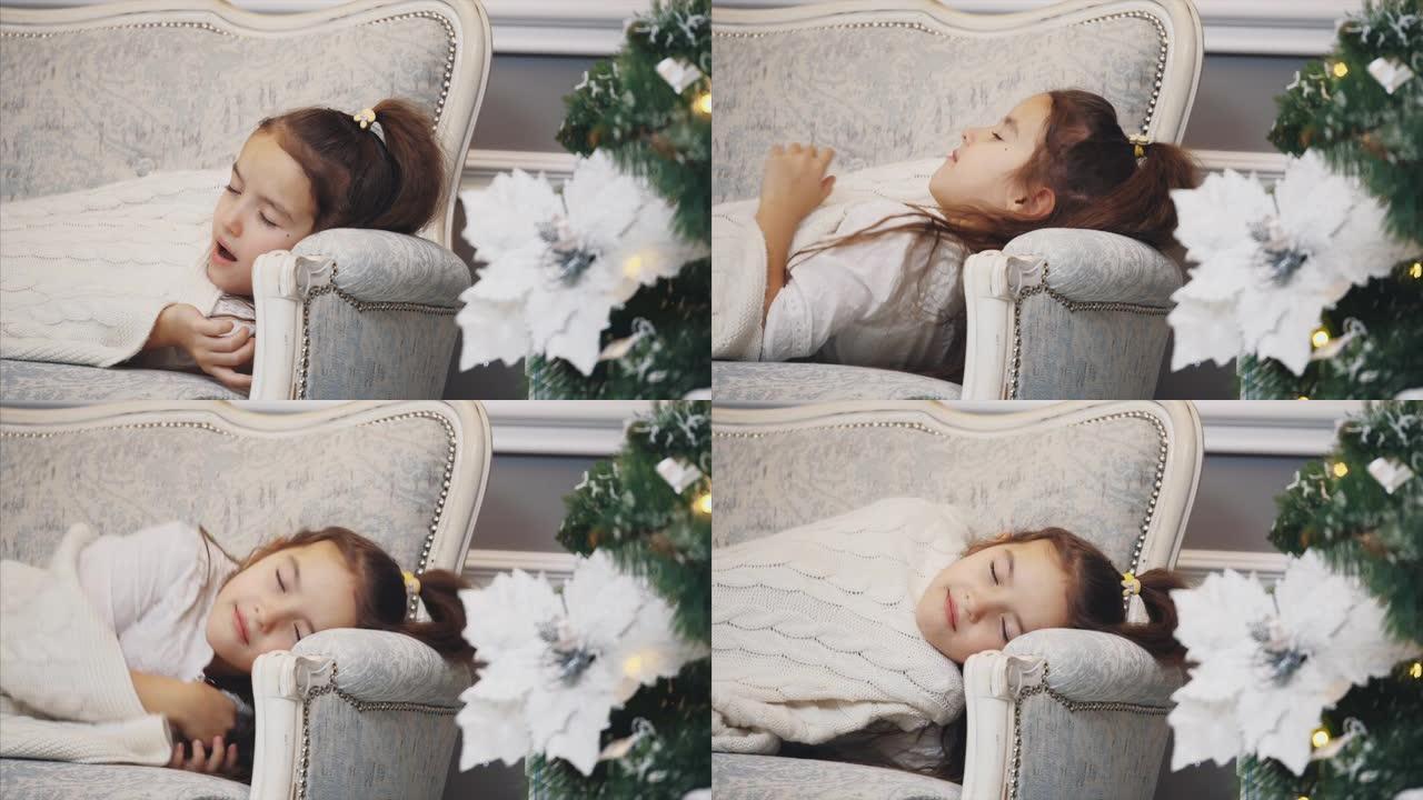 女儿在圣诞树附近的沙发上睡着的特写视频，早上醒来，打开礼品盒的包装。