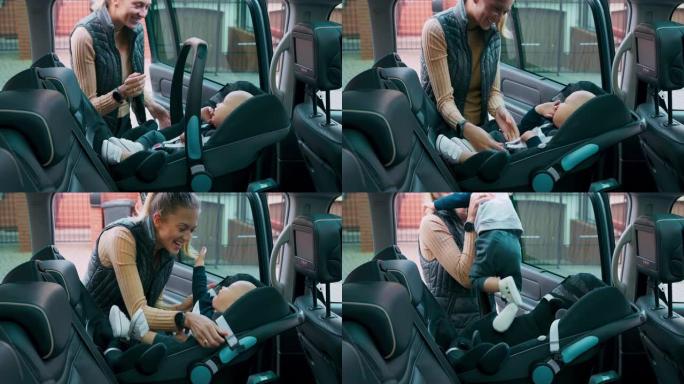 婴儿男孩在汽车座椅内。微笑的母亲打开门，放下把手，解开安全带，小心地将婴儿带出座位。关上门。慢动作