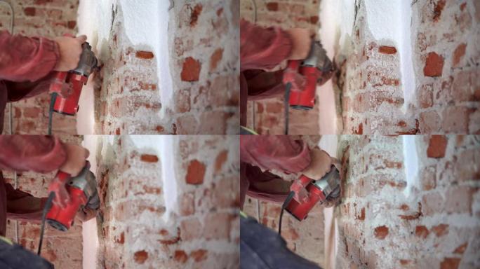 工人用电凿锤拆除砖墙