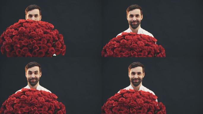 诱人的人站着，从大束红玫瑰后面出现，扬起眉毛，点点头。