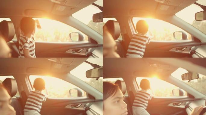 母亲和儿子在日落时开车