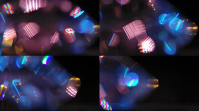 在珍贵晶体的多个方面反射的光的作用。在黑色背景上折射光和虹彩高光。彩色bokeh圆圈背景特写慢动作