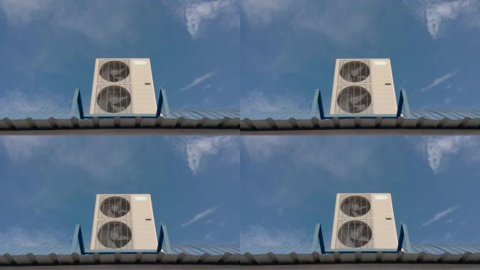 蓝天背景屋顶上的空调压缩机。手持镜头