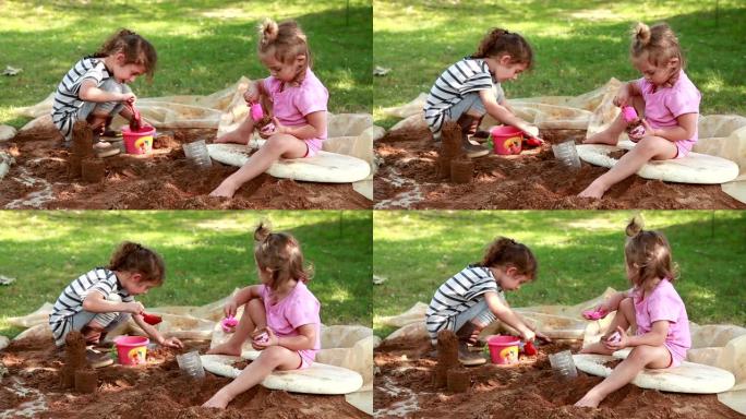 两个小女孩在后院玩沙子