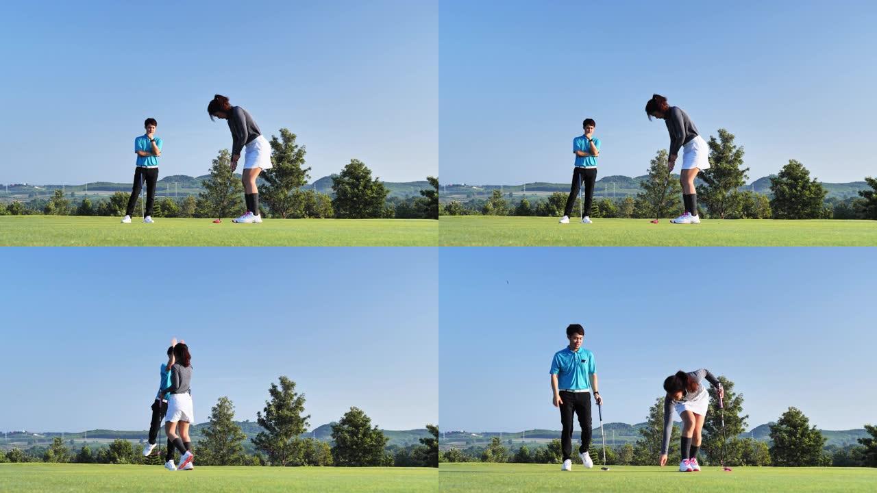 女人在夏天与男性比赛伙伴或教练在户外打职业高尔夫球时，计算球到洞的轨迹