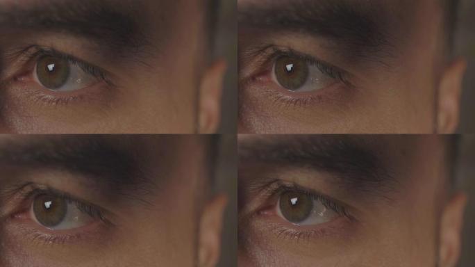 美丽的眨眼男性棕色眼睛特写。男性棕色眼睛张开人类虹膜宏观自然美。电影4k视频