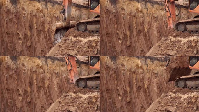 挖掘机在基坑中挖掘粘土以建立基础。挖掘机铁斗带地面，背景，行业