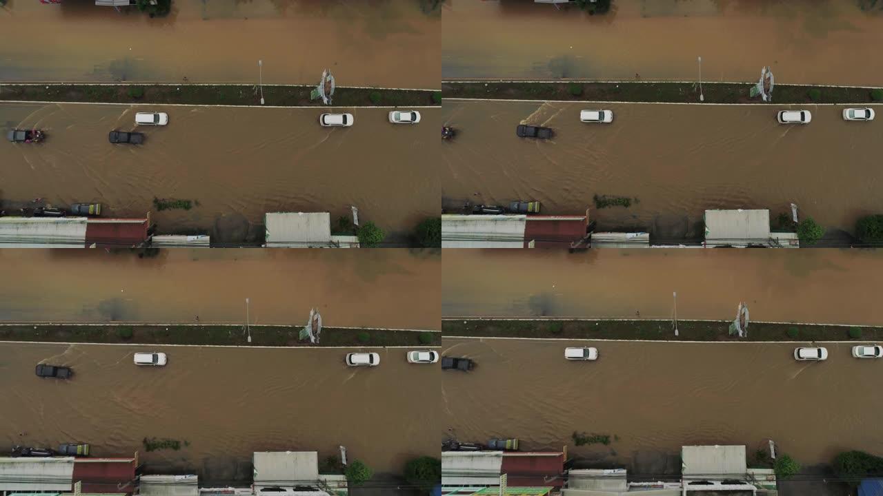 在洪水泛滥的道路上行驶的汽车的空中拍摄