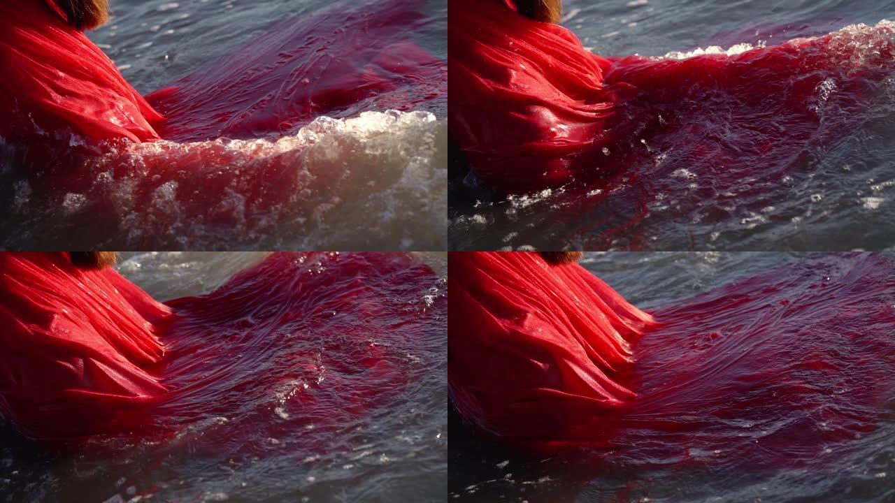 漂浮在海水上的蓬松连衣裙湿裙上的波浪卷