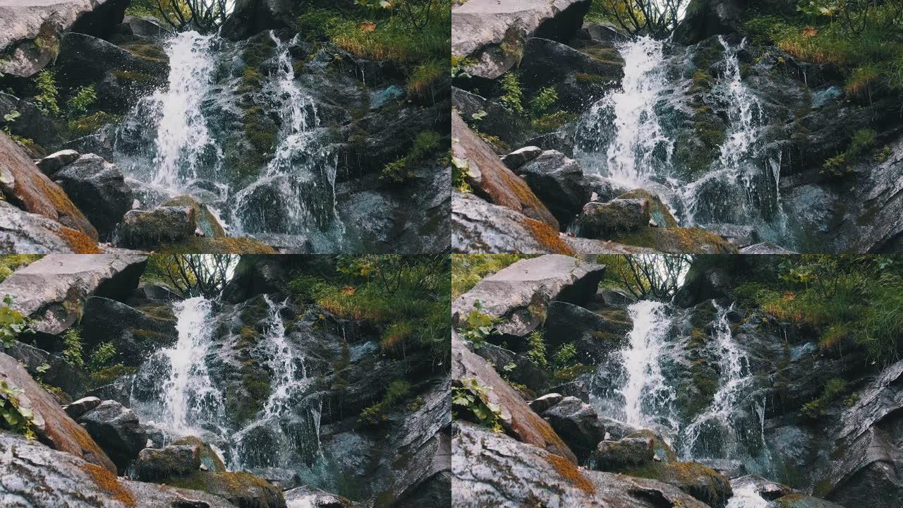 野生山瀑布。快速落水撞击石头。慢动作