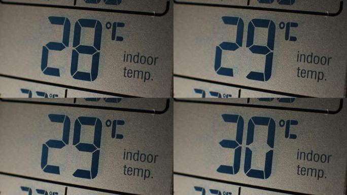 液晶屏温度计的极端特写，表明家庭室内温度升高
