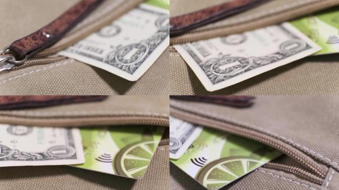 5美元的美国钞票和旋转桌子上的帆布袋口袋中的塑料信用卡。特写，浅景深