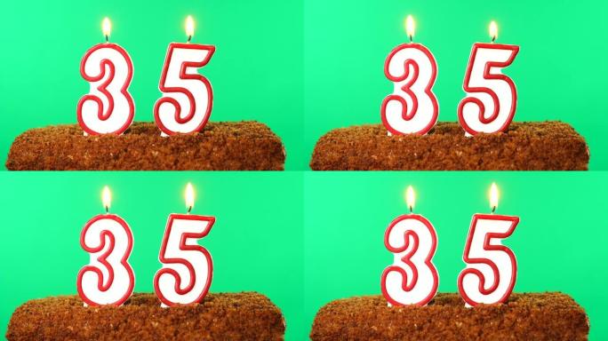 用35号点燃蜡烛的蛋糕。色度键。绿屏。隔离