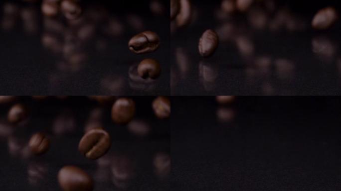 最好的咖啡。高级新鲜烘焙棕色咖啡豆滚动的慢动作镜头，落在木桌上，深色背景。咖啡谷物关闭4k视频