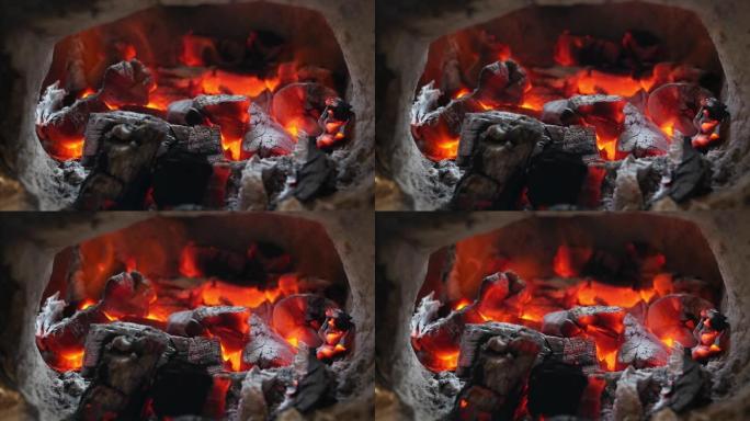 壁炉中白炽燃烧的煤的特写镜头，烧烤的热煤火和冬季圣诞节假期概念。